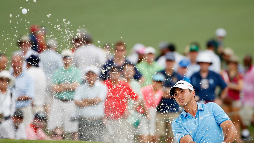 Tough outing ... Jason Day plays a bunker shot on the seventh hole during the second round