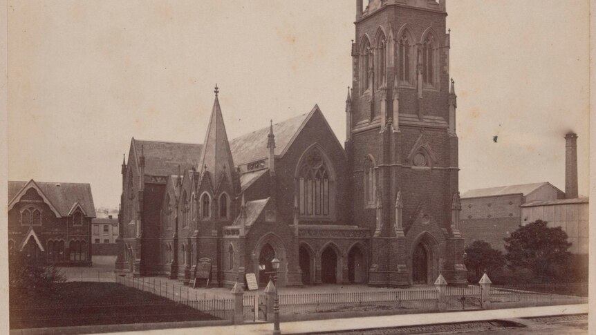 A historic sepia image of the Wesley Church, with a tall spire