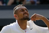 Nick Kyrgios winces and plucks at his shirt collar.