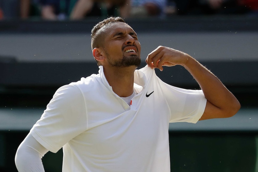 Nick Kyrgios winces and plucks at his shirt collar.