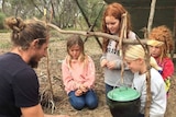 Steve Aldridge showing four girls how to make a fire in story about how 'wild schools' can help kids understand nature.