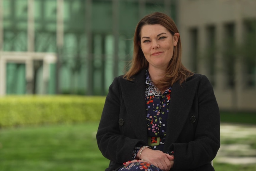 Sarah Hanson-Young sitting in the senate courtyard with the background out of focus