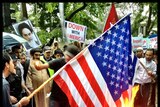 Bangkok protesters try to burn American flag