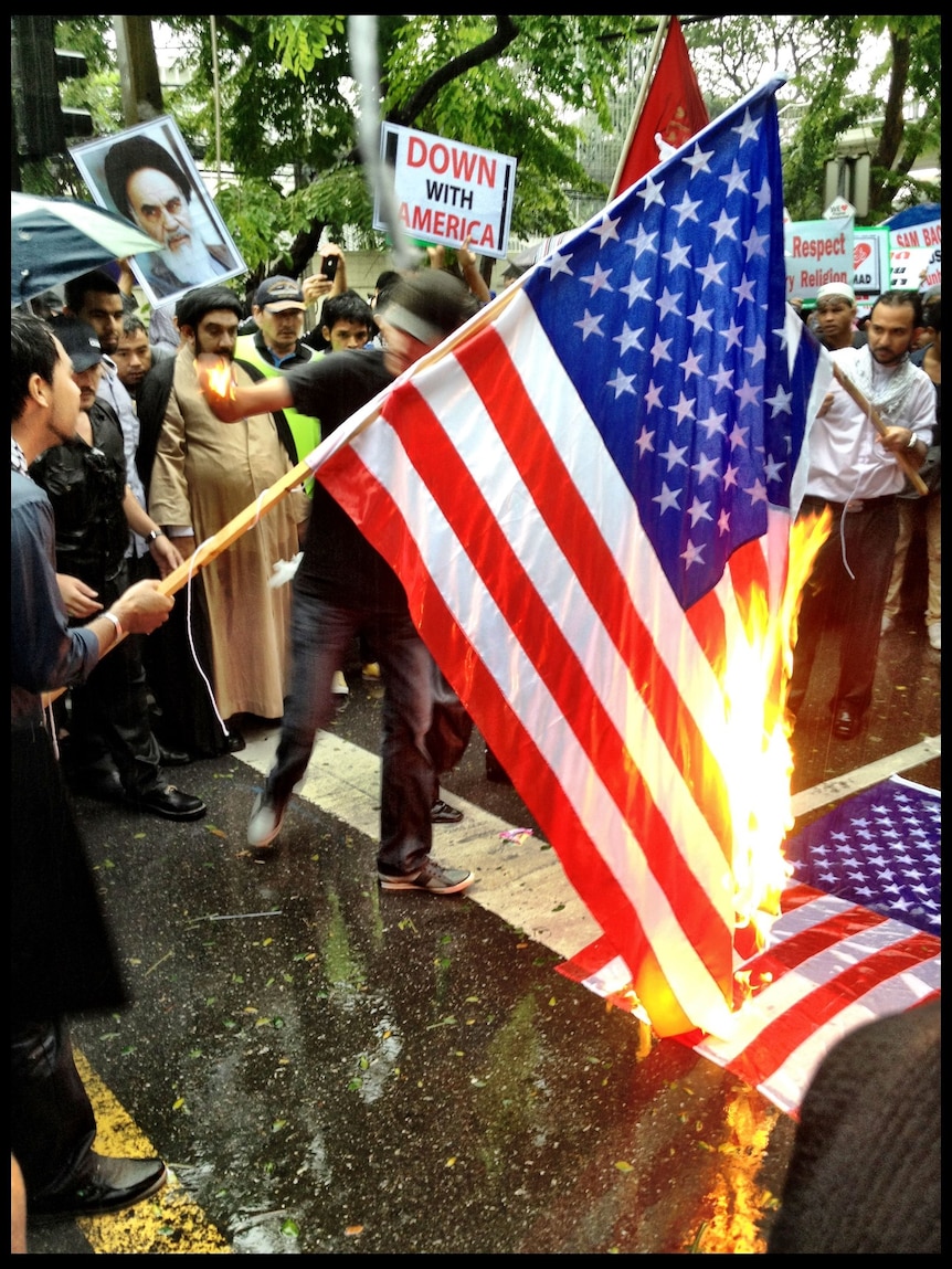Bangkok protesters try to burn American flag