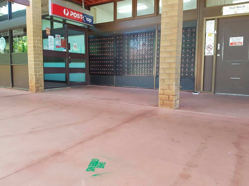 Greens logo sprayed on the ground outside a post office in Karratha