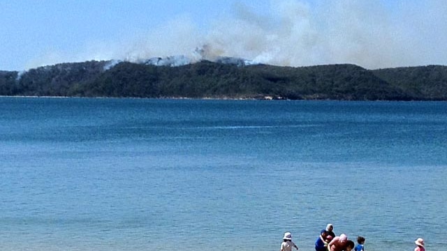 Smoke rises from a bushfire burning on the NSW central coast.