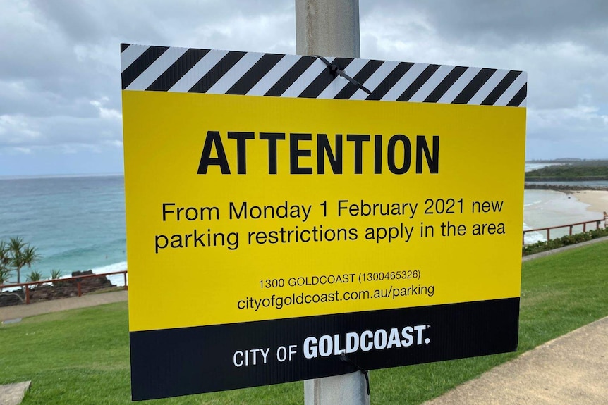 Gold Coast City Council sign notifying people that parking restrictions apply from 1 February.