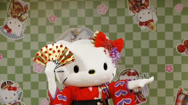 A performer dressed as a Hello Kitty mascot wearing a kimono