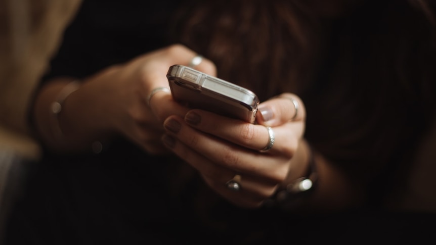 close up of woman's hands holding phone