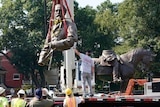 Crews gently lower the torso of Confederate General Robert E Lee