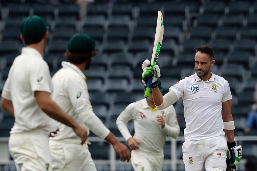 Faf du Plessis raises his bat as Australian players look on.