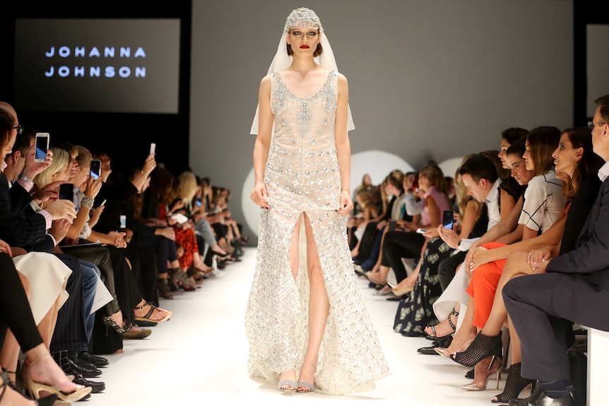 A Johanna Johnson wedding dress modelled on a runway.