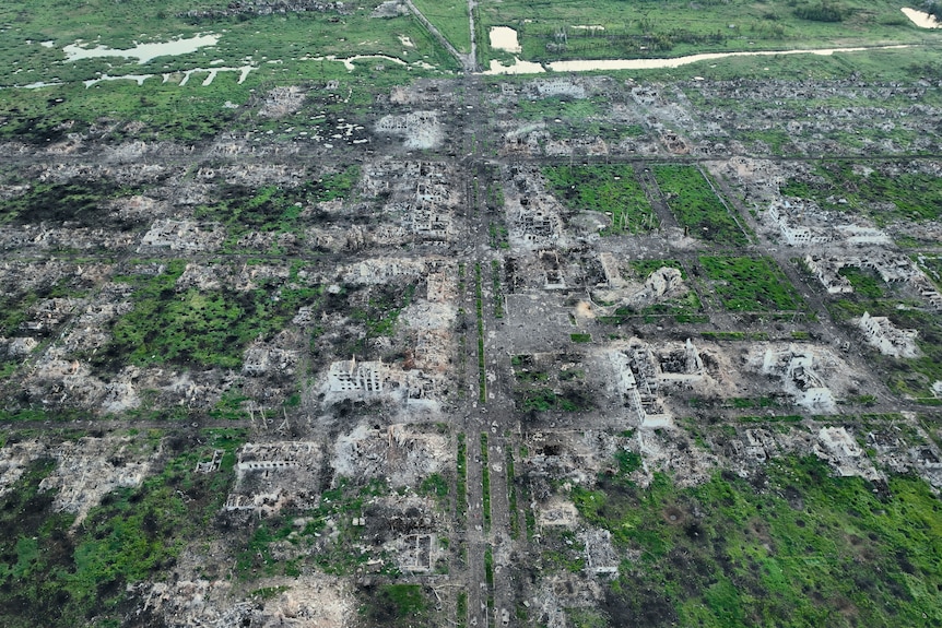 Residential buildings razed to the ground and shell craters are seen on an aerial view of Maryinka.
