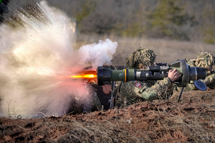 A Ukrainian serviceman fires an anti-tank weapon during a training exercise 