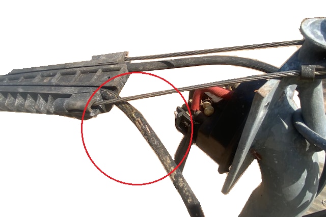 A computer-generated illustration of damaged insulation on an overhead powerline making contact with a wire.
