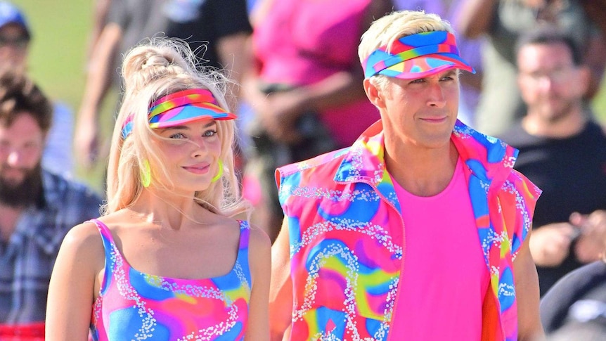 Margot Robbie and Ryan Gosling in matching neon outfits on the set of the movie "Barbie" in 2022