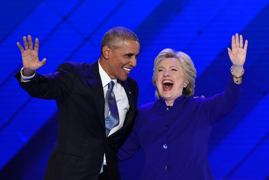 Barack Obama stands on stage with Hillary Clinton