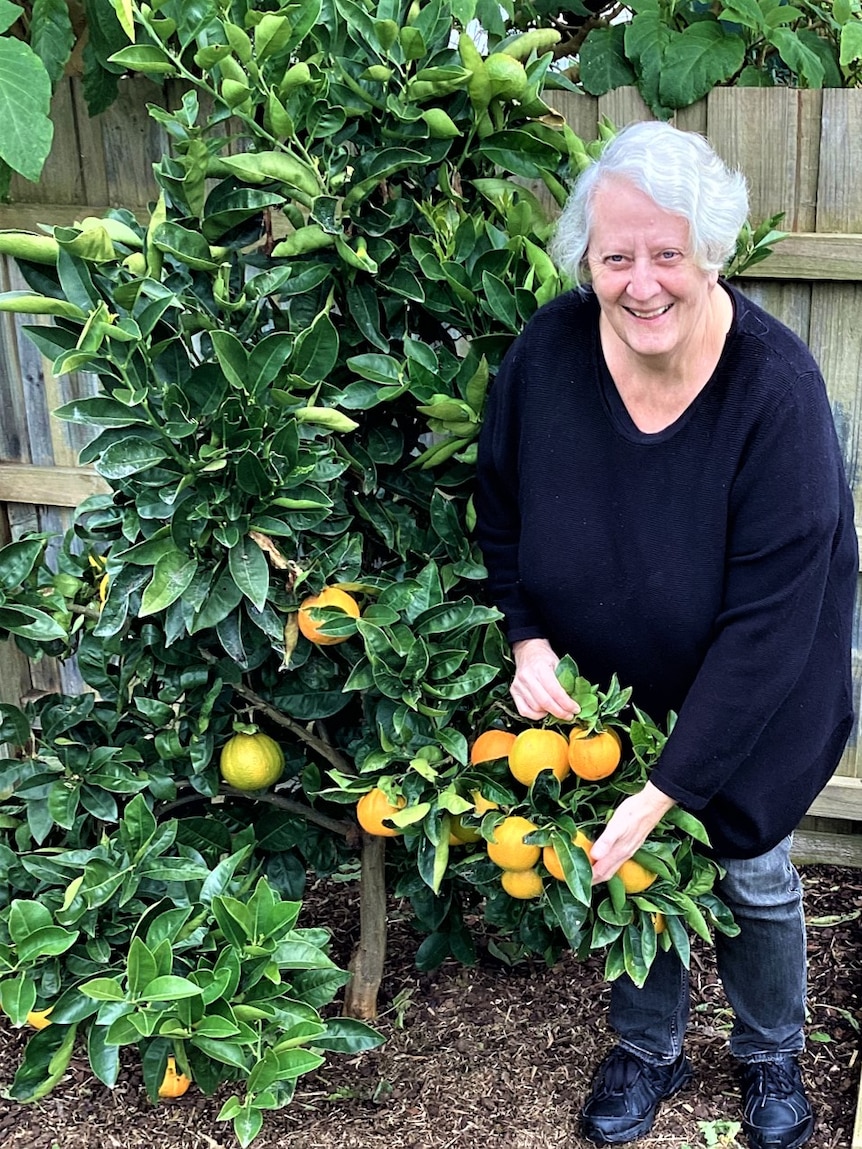 Jane Bari poses with some vegetables