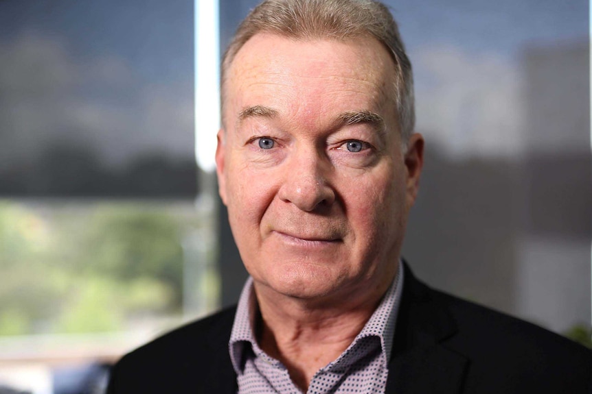 A headshot of Paul Armstrong in an office.