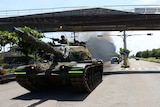 A tank passes under a flyover during military drills in Taiwan