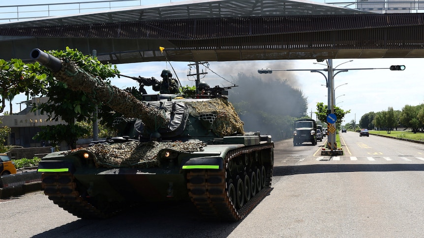 A tank passes under a flyover during military drills in Taiwan