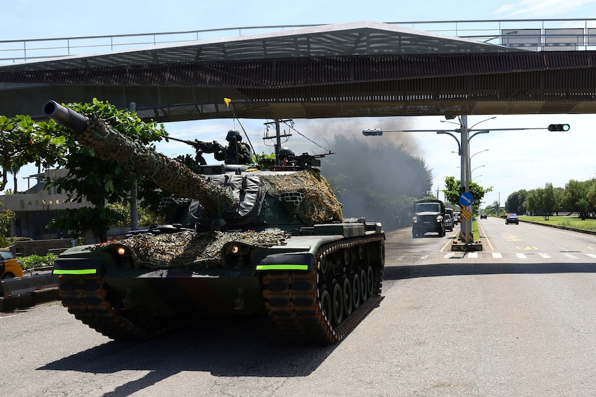 A tank passes under a flyover during military drills in Taiwan