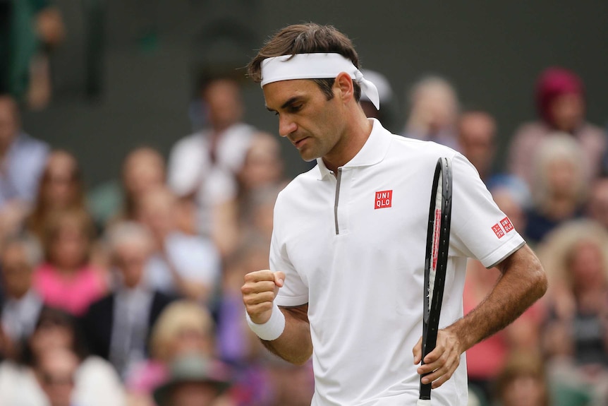Roger Federer clenches his fist during the Wimbledon final against Novak Djokovic.