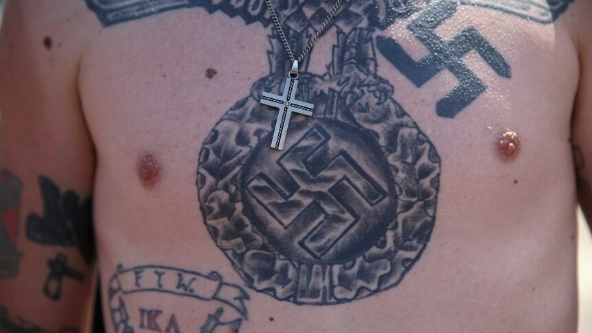 The tattooed chest of a Ku Klux Klan member during a protest in South Carolina.