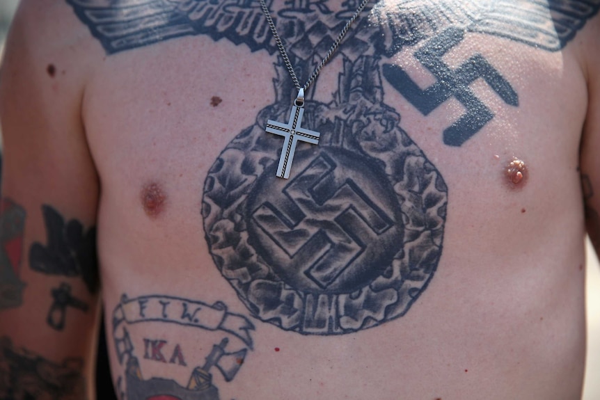 The tattooed chest of a Ku Klux Klan member during a protest in South Carolina.