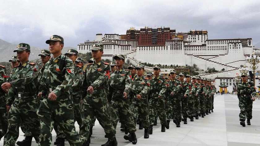 People's Armed Police soldiers patrol in front of Potala Palace.