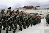 People's Armed Police soldiers patrol in front of Potala Palace.