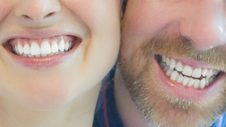 Couple smiling with white teeth.