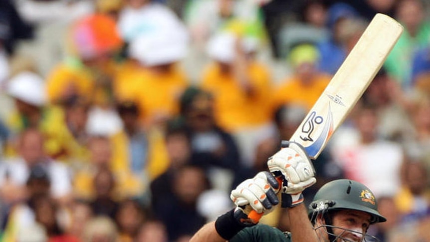 Australian batsman Michael Hussey drives during the tri-series one-day clash
