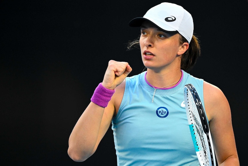 Iga Swiatek pumps her right fist at the Australian Open.