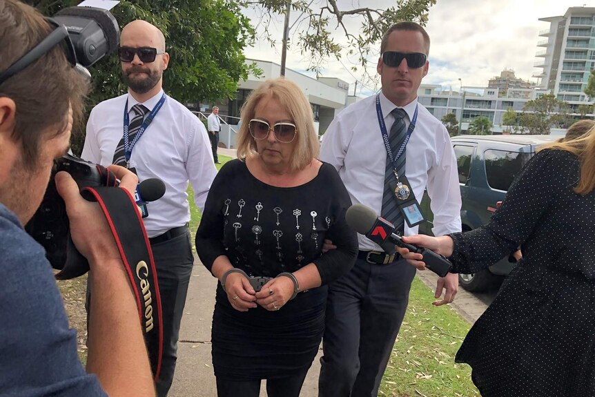 Sharon Graham being led by police after being arrested in Coolangatta