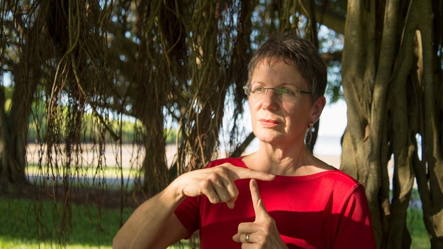 Sharon Roneberg makes a 'T' with her hands.