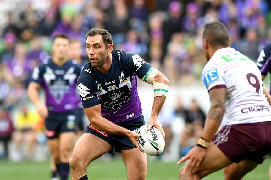Cameron Smith of the Storm passes the ball.