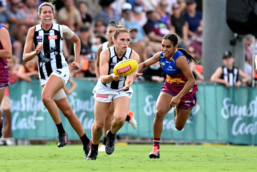 AFL player Alana Porter of the Magies is chased by Courtney Hodder of the Lions