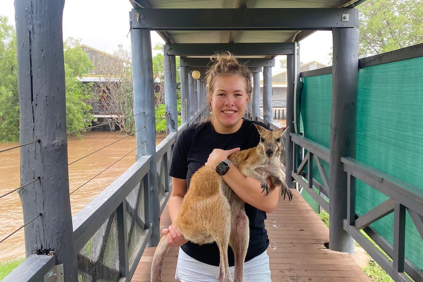 Woman carrying a wallaby