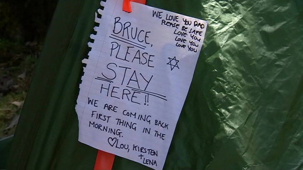 Sign left by family members on tent owned by Bruce Fairfax