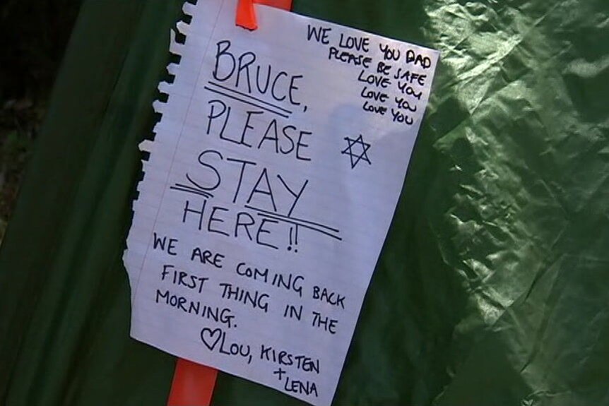 Sign left by family members on tent owned by Bruce Fairfax