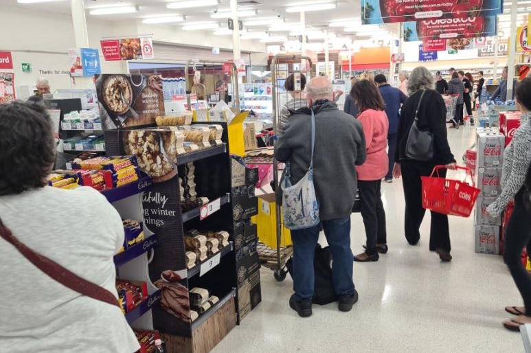 Customers line up with their groceries at a Coles store in Kaleen in Canberra.