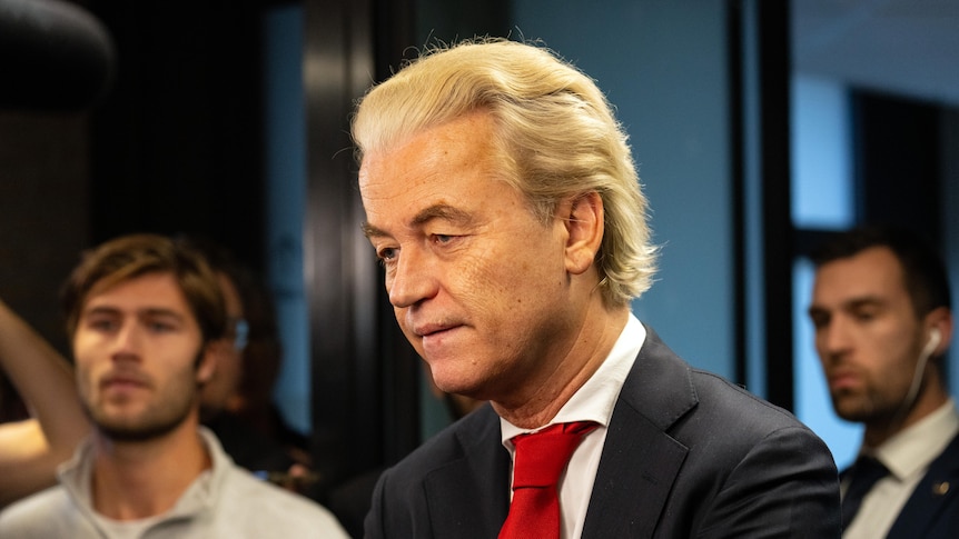 side profile of Geert Wilders wearing suit with red tie