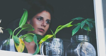 Woman with pot plants in front of her