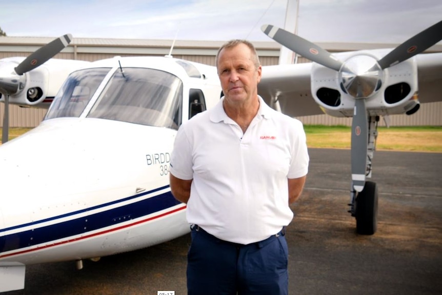 Man standing in front of an aircraft