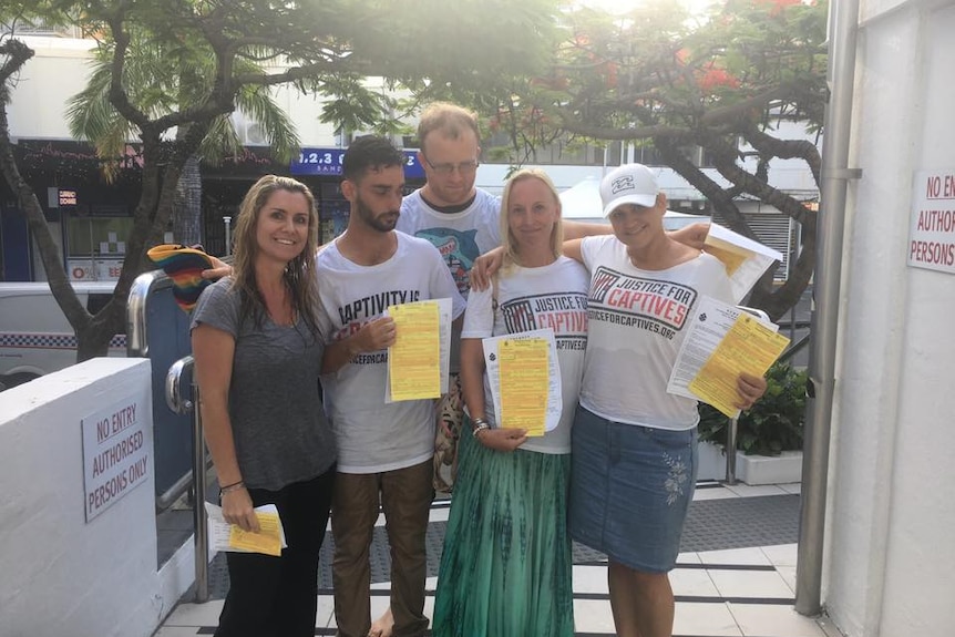 A group of activists holding up their fines from police.