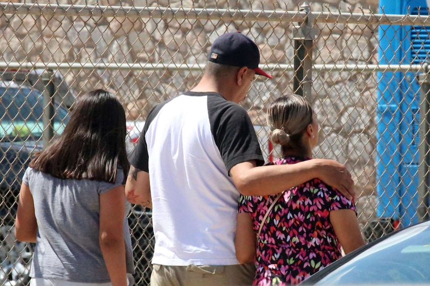 people walk out of a school in El Paso