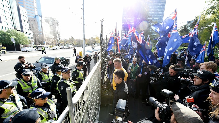 Protesters calling themselves patriots from the UPF and the True Blue Crew blocked by police at a gate in Melbourne.