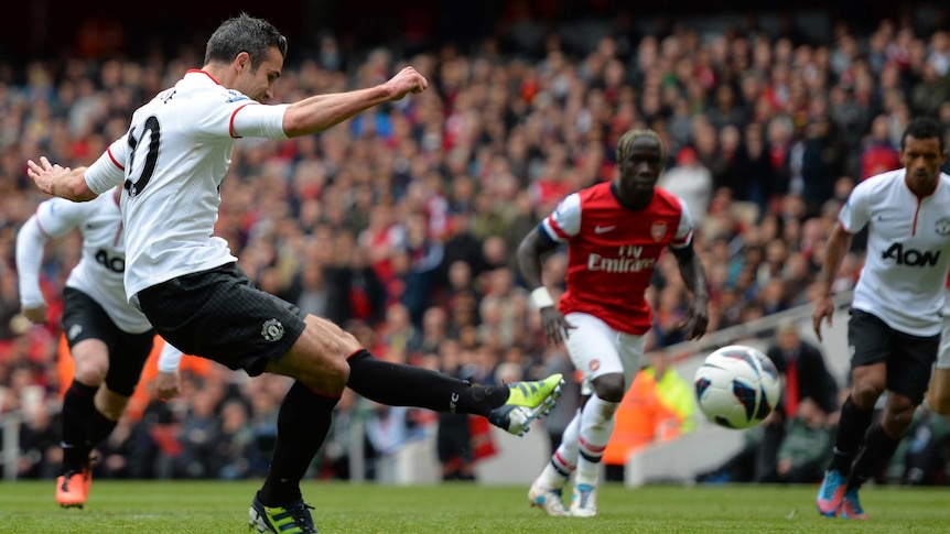 Robin van Persie of Manchester United scores from the penalty spot during his team's match with Arsenal.