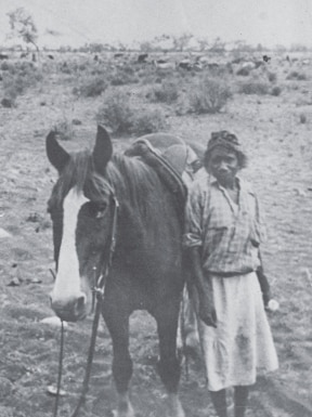 Maudie Moore standing next to her horse.